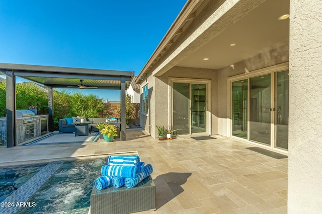 view of patio / terrace with ceiling fan and an outdoor kitchen