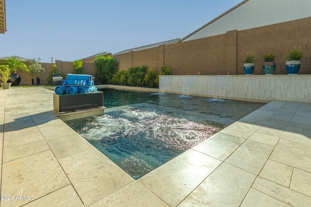 view of pool featuring pool water feature, an outdoor living space, and a patio