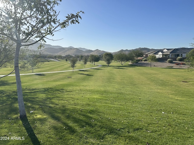 view of community featuring a mountain view and a lawn