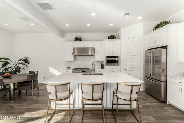 kitchen featuring a kitchen island with sink, sink, and stainless steel appliances