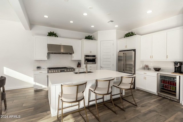 kitchen with wine cooler, sink, stainless steel appliances, and dark wood-type flooring