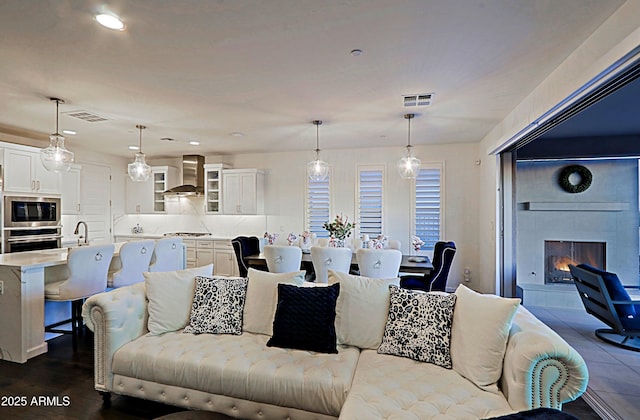 living room with a tile fireplace