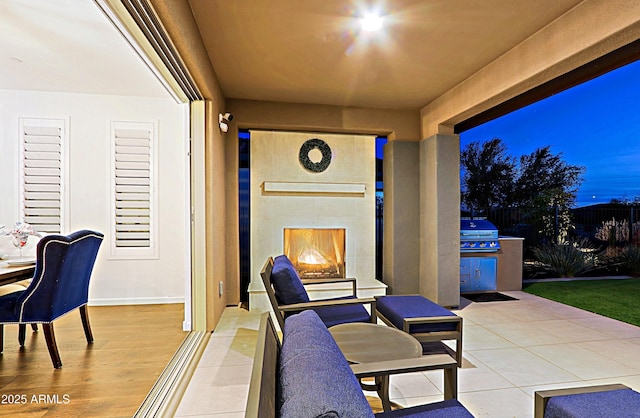 view of patio with an outdoor fireplace, area for grilling, and grilling area