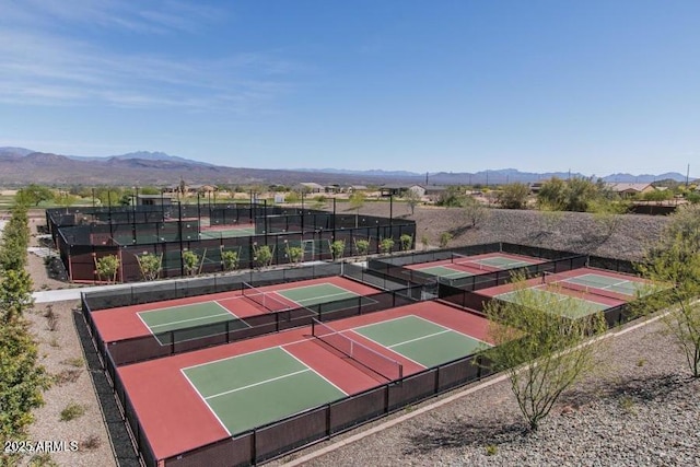 view of tennis court featuring a mountain view