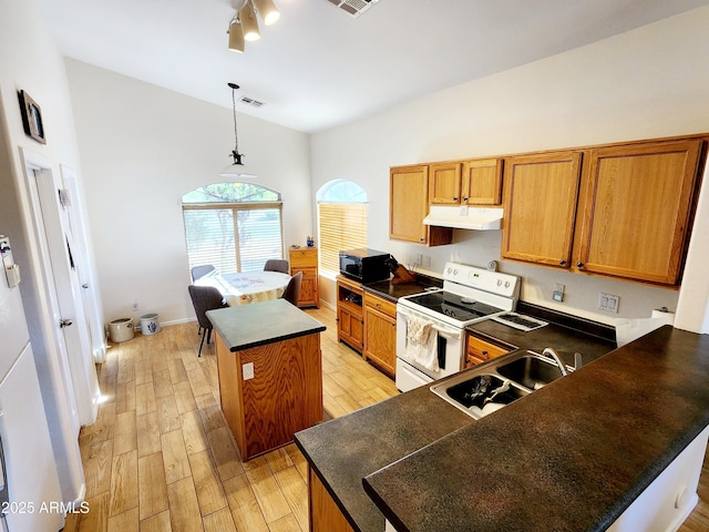 kitchen with electric stove, sink, pendant lighting, lofted ceiling, and a kitchen island