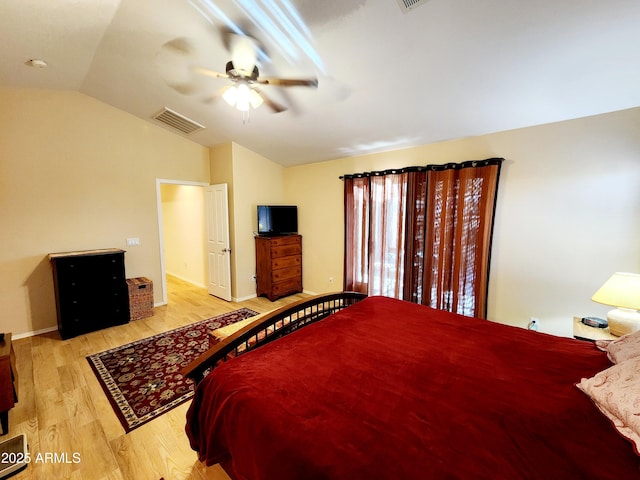 bedroom featuring ceiling fan, lofted ceiling, and light wood-type flooring