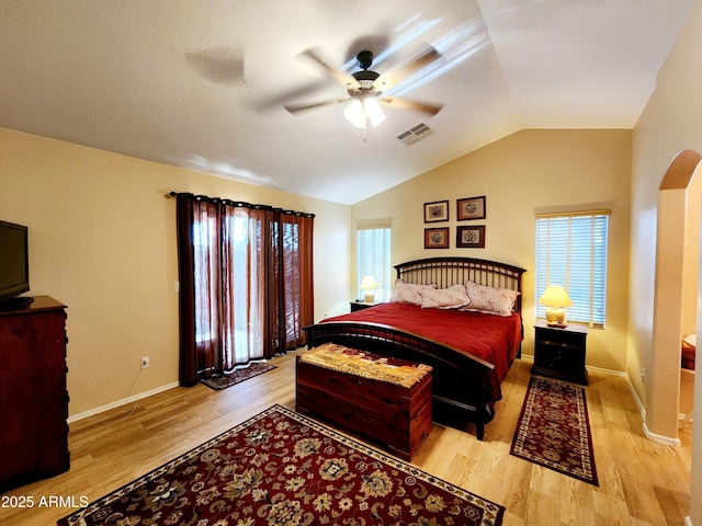 bedroom with ceiling fan, vaulted ceiling, and light hardwood / wood-style flooring