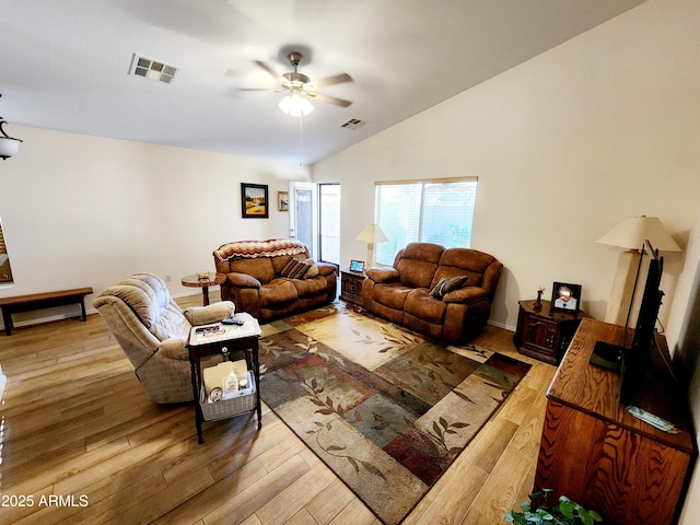 living room featuring vaulted ceiling, ceiling fan, and hardwood / wood-style floors