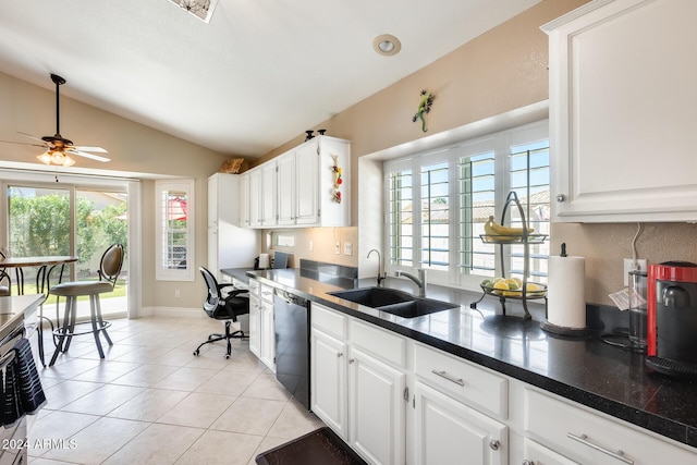 kitchen with black dishwasher, light tile patterned floors, lofted ceiling, dark countertops, and a sink