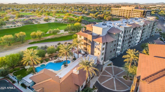 drone / aerial view with a mountain view and golf course view