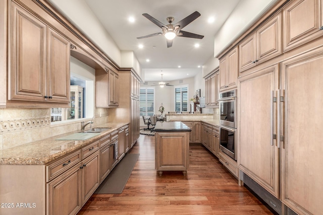 kitchen with a ceiling fan, built in fridge, stainless steel double oven, wood finished floors, and tasteful backsplash