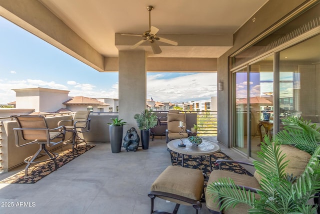 view of patio / terrace with ceiling fan and a balcony