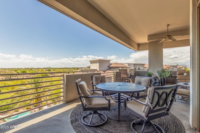 balcony featuring outdoor dining area and ceiling fan