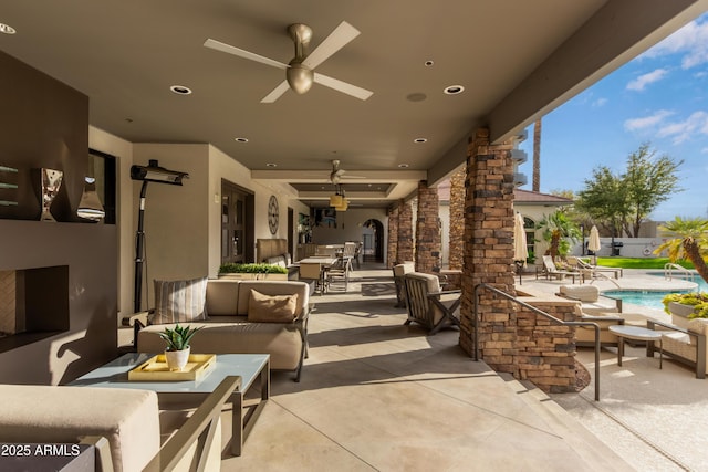 view of patio / terrace with an outdoor hangout area, a fenced in pool, and a ceiling fan