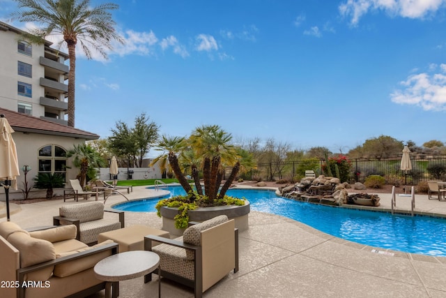 pool featuring fence, a patio, and outdoor lounge area