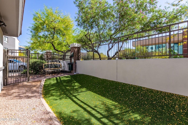 view of yard featuring fence and a gate