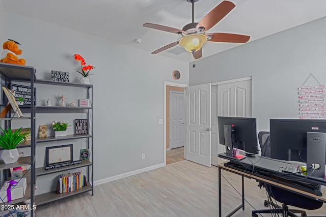 home office featuring ceiling fan and light hardwood / wood-style flooring