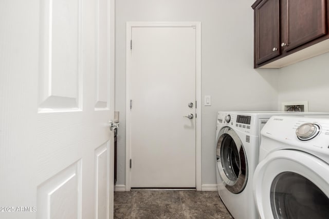 washroom featuring separate washer and dryer and cabinets