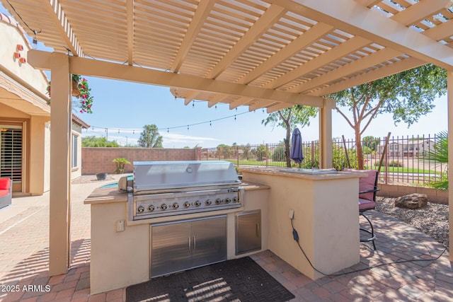 view of patio / terrace featuring exterior kitchen, a pergola, and grilling area