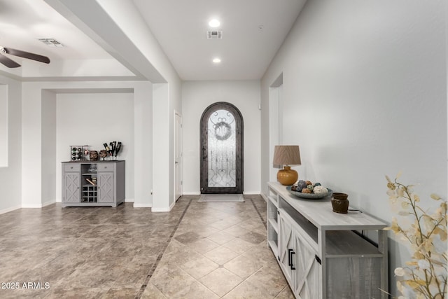 tiled foyer entrance featuring ceiling fan