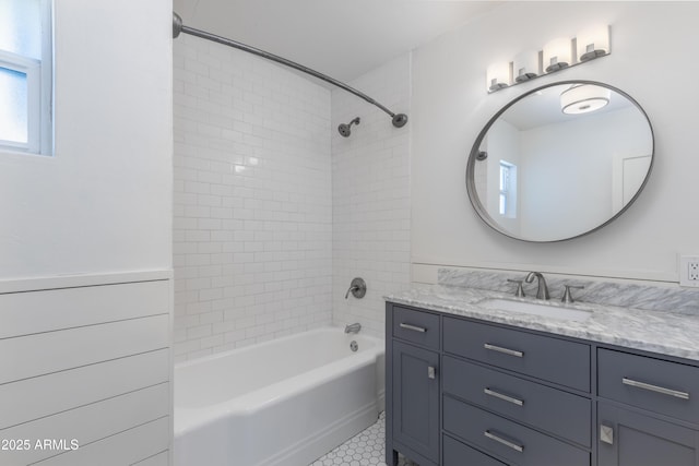 bathroom with tiled shower / bath, vanity, and tile patterned flooring