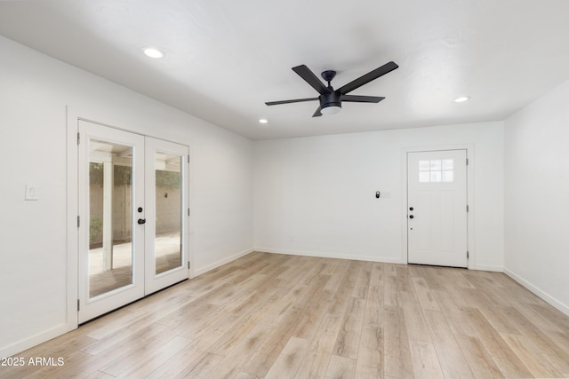 spare room featuring french doors, ceiling fan, and light wood-type flooring