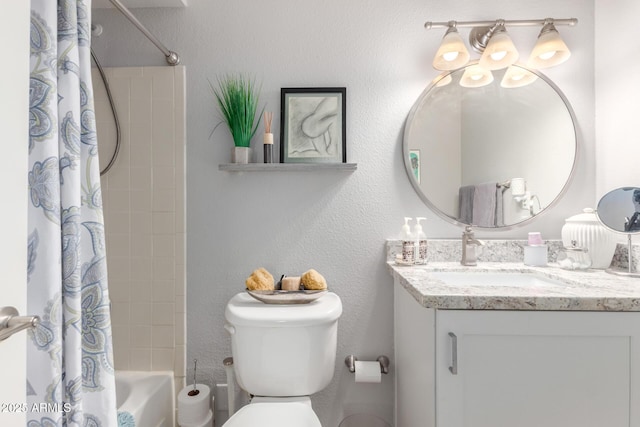 bathroom featuring a textured wall, shower / tub combo with curtain, vanity, and toilet