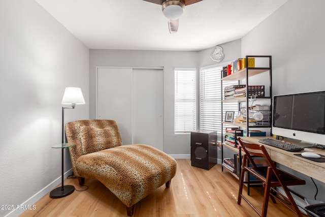 office space with baseboards and wood finished floors