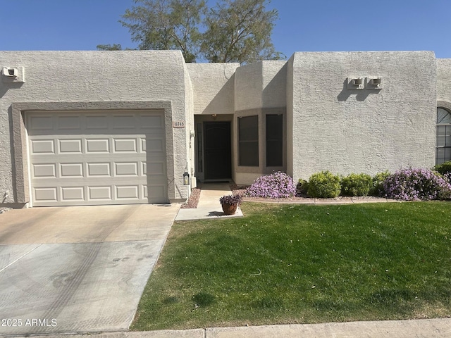 view of front facade featuring driveway, an attached garage, a front yard, and stucco siding