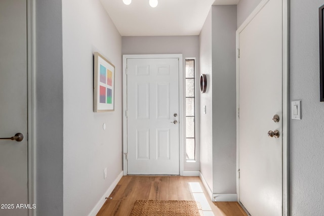 interior space featuring light wood-style flooring and baseboards