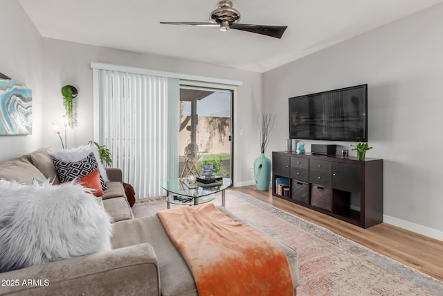 living area featuring ceiling fan, wood finished floors, and baseboards