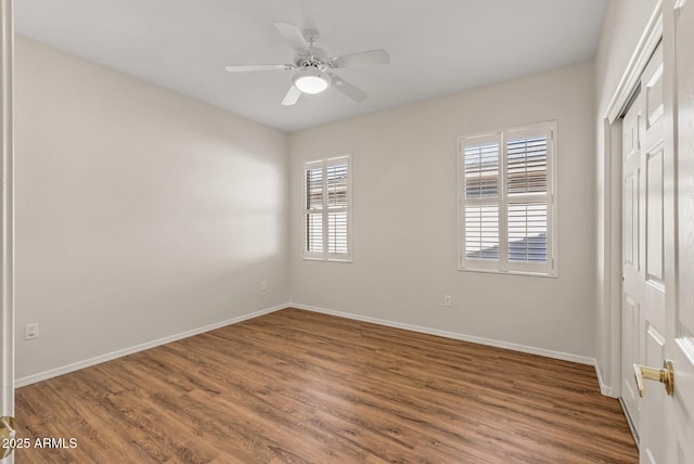 unfurnished bedroom with hardwood / wood-style flooring, a closet, and ceiling fan