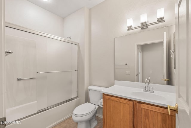 full bathroom featuring vanity, shower / bath combination with glass door, and toilet