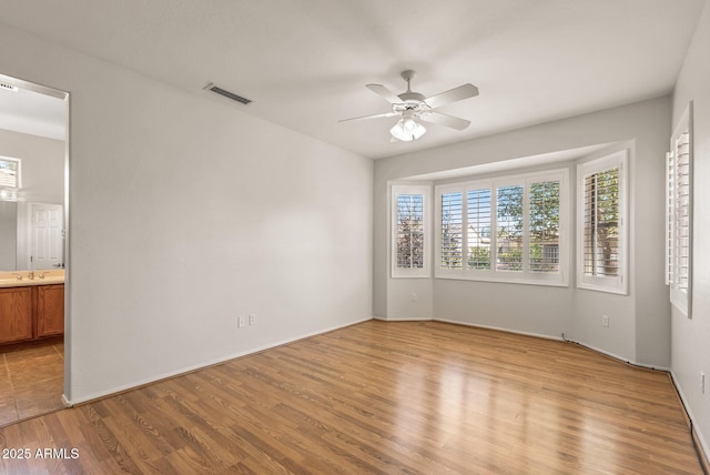 unfurnished room with ceiling fan and light hardwood / wood-style flooring