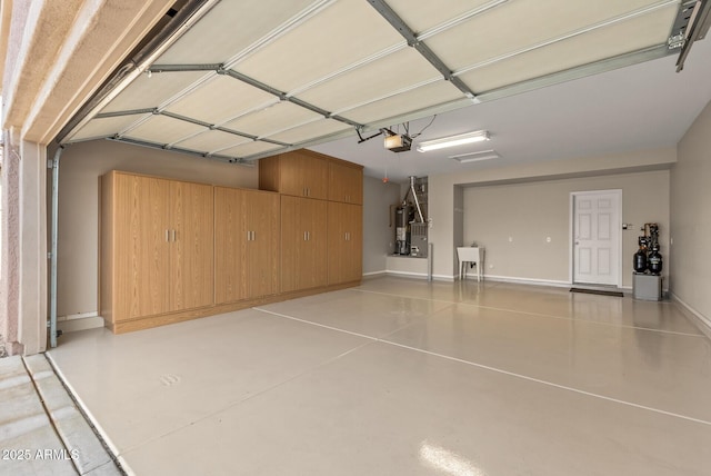 garage featuring sink, a garage door opener, and water heater