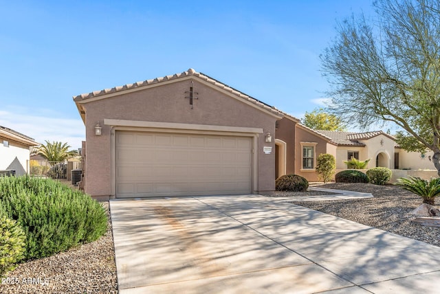 view of front of home featuring a garage and central AC unit