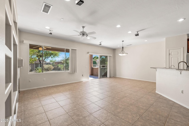 tiled empty room with ceiling fan