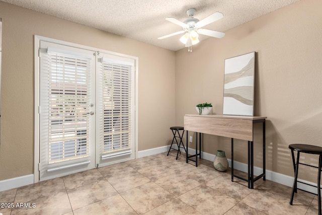 office with a textured ceiling, baseboards, and ceiling fan