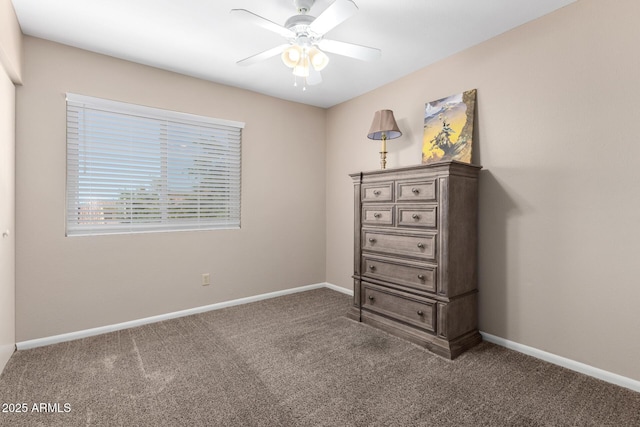 unfurnished bedroom with baseboards, carpet, and a ceiling fan