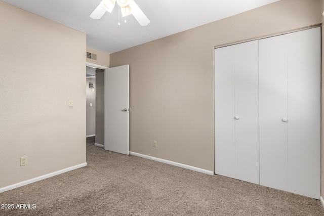 unfurnished bedroom featuring a ceiling fan, visible vents, baseboards, a closet, and carpet flooring