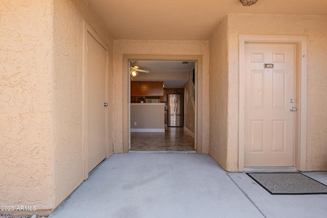 property entrance with stucco siding