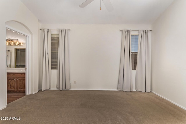 empty room with ceiling fan and carpet