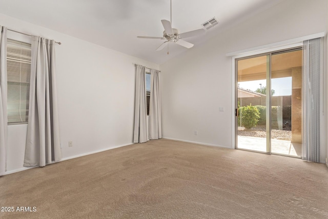 carpeted empty room featuring ceiling fan and lofted ceiling