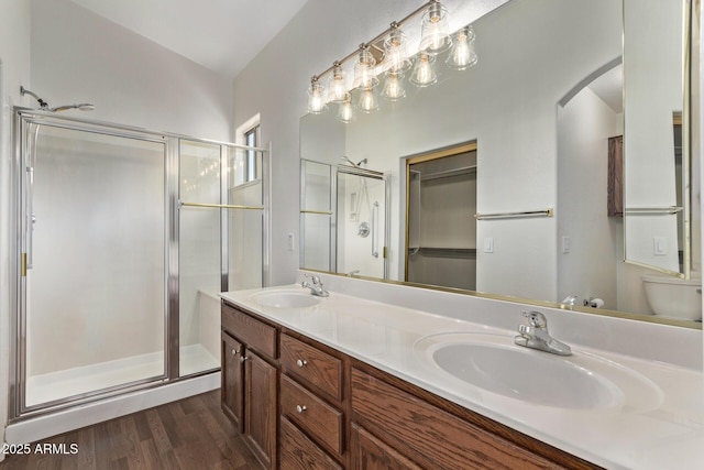 bathroom with toilet, vaulted ceiling, hardwood / wood-style floors, an enclosed shower, and vanity