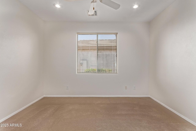 carpeted empty room featuring ceiling fan and a wealth of natural light