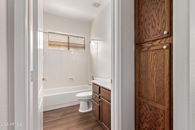 full bathroom featuring toilet, vanity, hardwood / wood-style flooring, and bathtub / shower combination