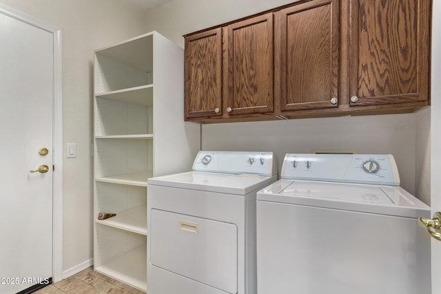 laundry area with washer and dryer and cabinets