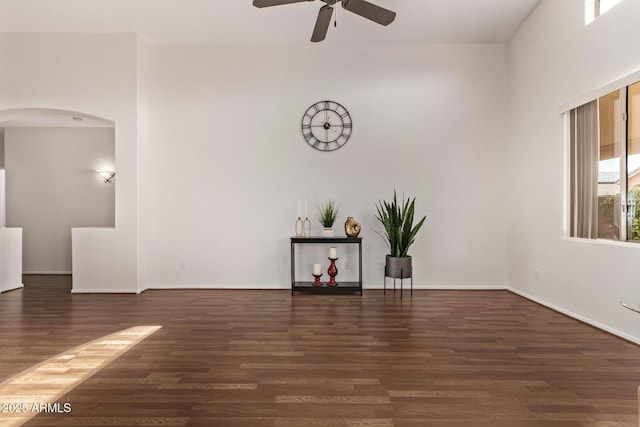 unfurnished room with dark hardwood / wood-style flooring and ceiling fan