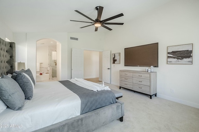 bedroom with arched walkways, visible vents, light carpet, ceiling fan, and baseboards