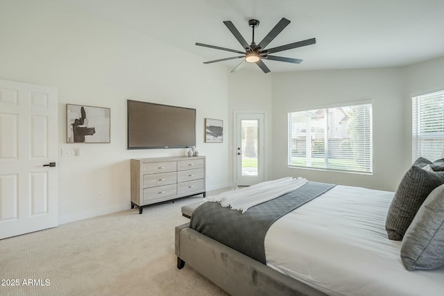 bedroom featuring a ceiling fan, light colored carpet, vaulted ceiling, and baseboards